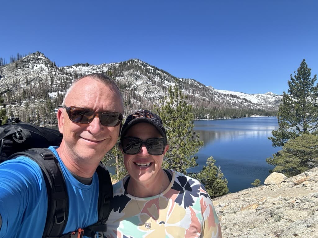 Jason and Trisha Shultz hiking at a mountain lake
